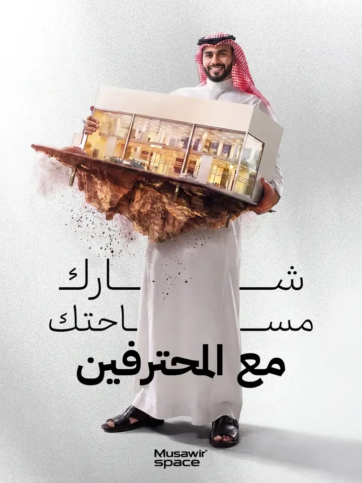 إعلان لمنصة حجز مواقع تصوير: شاب بالثوب يحمل قطعة أرض فوقها استوديو مضاء بجدار زجاجي